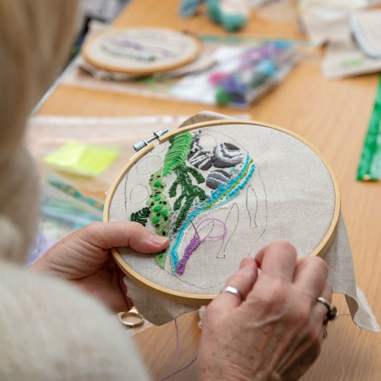 Woman stitching tapestry