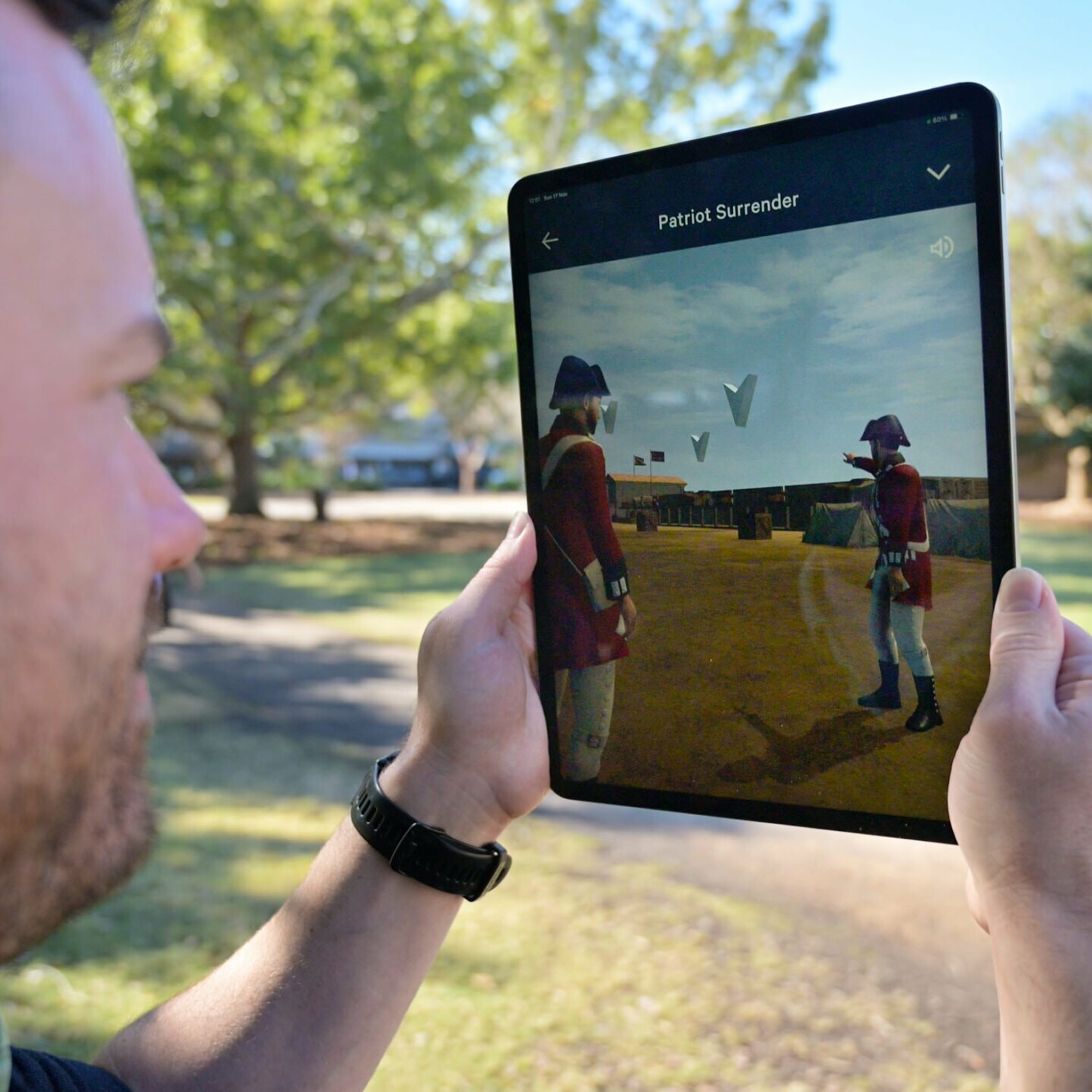 Person using Liberty Trail AR app on an ipad, in Marion Square, Charleston